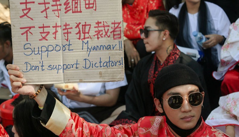 In this file photo taken on February 11, 2021, model, actor and singer Paing Takhon wears a traditional Chinese outfit while holding a sign during a demonstration against the military coup in front of the Chinese embassy in Yangon. — AFP photo
