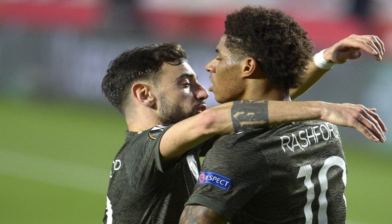 Manchester United striker Marcus Rashford (R) celebrates with team-mate Bruno Fernandes after scoring his team’s opening goal against Granada during their UEFA Europa League match at the Nuevo Los Carmenes stadium in Granada on Thursday. — AFP photo