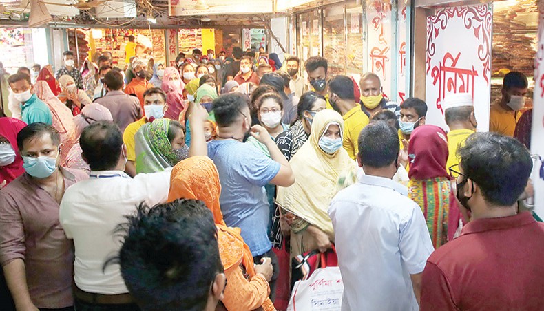 Shoppers crowd a clothes store at Gausia Market in Dhaka on Friday as the store offered discount on its items amid worsening COVID-19 situation. — Sony Ramany