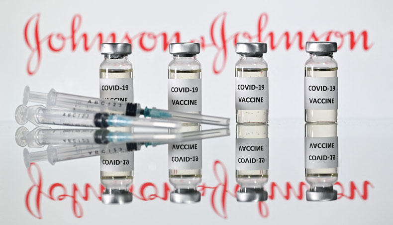 A file photo taken on November 17, 2020 shows vials with COVID-19 vaccine stickers attached and syringes with the logo of US pharmaceutical company Johnson & Johnson in London. — AFP photo