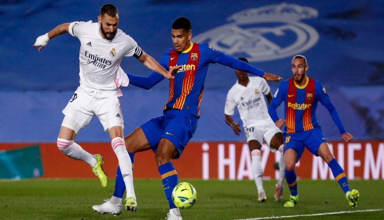 Real Madrid forward Karim Benzema (L) flicks the ball to score his team’s opening goal against Barcelona during their La Liga match at the Alfredo Di Stefano Stadium in Madrid on Saturday. — Twitter photo