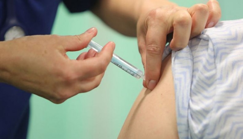 A healthcare professional administers an injection of the Moderna COVID-19 vaccine at a vaccination centre at Ffwrnes Theatre in Llanelli, South Wales, on April 9, 2021. -- AFP photo
