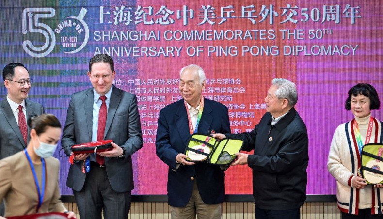 This photo taken on April 10, 2021 shows US Consul General in Shanghai James Heller (2nd L) with former Chinese table tennis players and ‘ping-pong diplomacy’ participants Zhang Xielin (centre L) and Zheng Minzhi (far R) receiving souvenirs during a ceremony to mark the 50th anniversary of the diplomatic event at the International Table Tennis Federation museum in Shanghai.— AFP photo