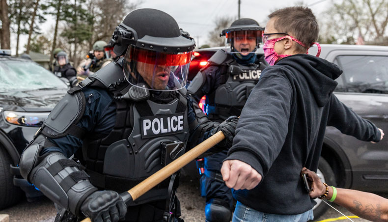 Protesters confront police officers in riot gear after an officer shot and killed a black man in Brooklyn Centre, Minneapolis, Minnesota on April 11, 2021. — AFP photo