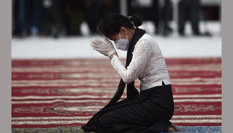 In this file photo taken on July 19, 2020, Myanmar’s the then state counsellor and foreign minister Aung San Suu Kyi wears gloves and a face mask as she pays her respects to her late father during a ceremony to mark the 73rd anniversary of Martyrs’ Day in Yangon. — AFP Photo