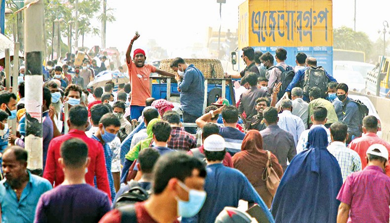 Homebound people set out for their village homes by goods-laden transports defying the health guidelines after government announces a seven-day lockdown beginning from April 14. The photo was taken from Gabtoli bus stand area in Dhaka on Monday. — Sony Ramany