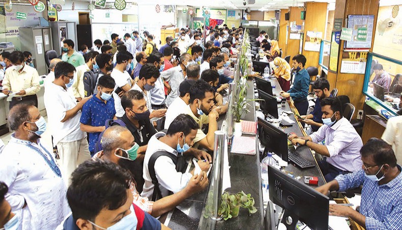 People crowd in large numbers to take service at a counter at a bank in the capital Tuesday as the government declared on Monday that banks would remain closed during a movement restriction imposed in April 14-21 to contain the COVID-19 outbreak. The government backtracked on the decision on Tuesday allowing the banks to operate during the restriction period. — New Age photo