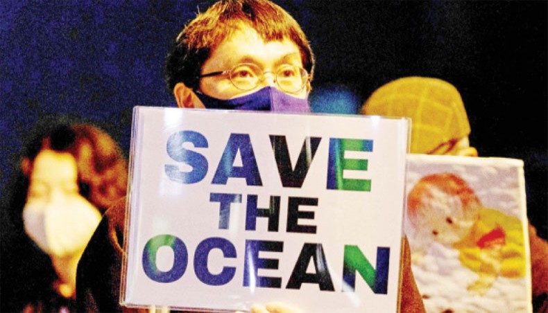 A protestor holds a slogan during a rally against the Japanese government’s decision to release treated water from the stricken Fukushima Daiichi nuclear plant into the sea, outside of the prime minister’s office in Tokyo on Tuesday. — AFP photo