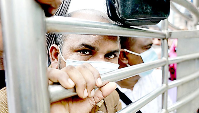 Bangladeshi migrant workers wait outside the Saudia airlines office in Dhaka, Bangladesh for air tickets to return to Saudi Arabia on September 24, 2020. — PA Images/ABACA/Suvra Kanti Das