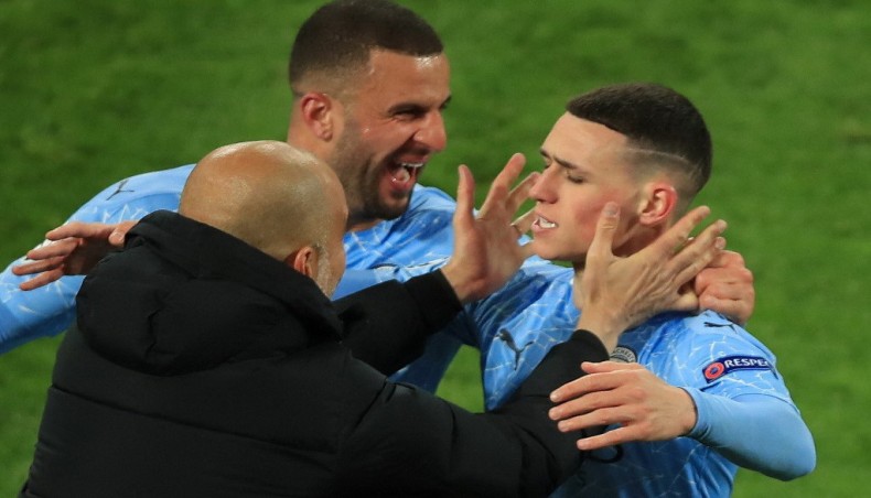 Manchester City midfielder Phil Foden (R) celebrates his team’s second goal against Borussia Dortmund with defender Kyle Walker and manager Pep Guardiola (L) during their UEFA Champions League quarter-final second leg match at the Signal Iduna Park in Dortmund on Wednesday. — AFP photo