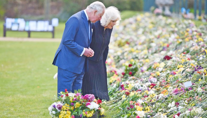Britain’s Prince Charles, Prince of Wales, left, and Britain’s Camilla, Duchess of Cornwall visit the gardens of Marlborough House in London on Thursday, to view the flowers and messages of condolence left by members of the public outside Buckingham Palace, following the April 9 death of Britain’s Prince Philip, Duke of Edinburgh. The Duke of Edinburgh, who died last Friday, will be buried on April 17 at Windsor Castle, west of London, with just 30 mourners, most of them close family. — AFP photo