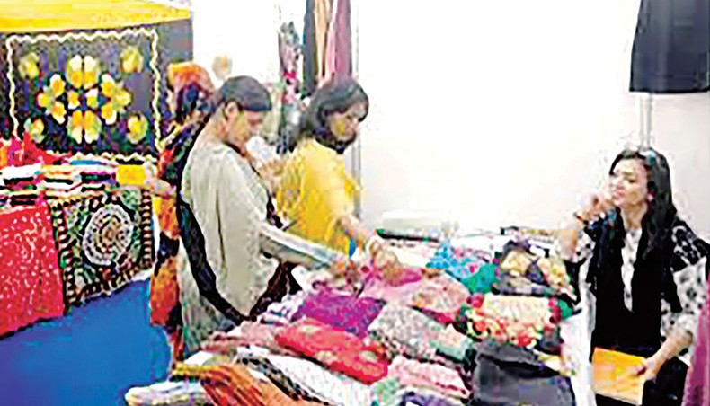 A file photo shows visitors browsing products at a stall at an SME fair held in Dhaka. Almost 59 per cent of women entrepreneurs in the cottage, micro, small and medium enterprise (CMSME) sector has not heard of the government stimulus packages for the sector, according to findings of a study conducted by the Centre for Policy Dialogue.— New Age photo