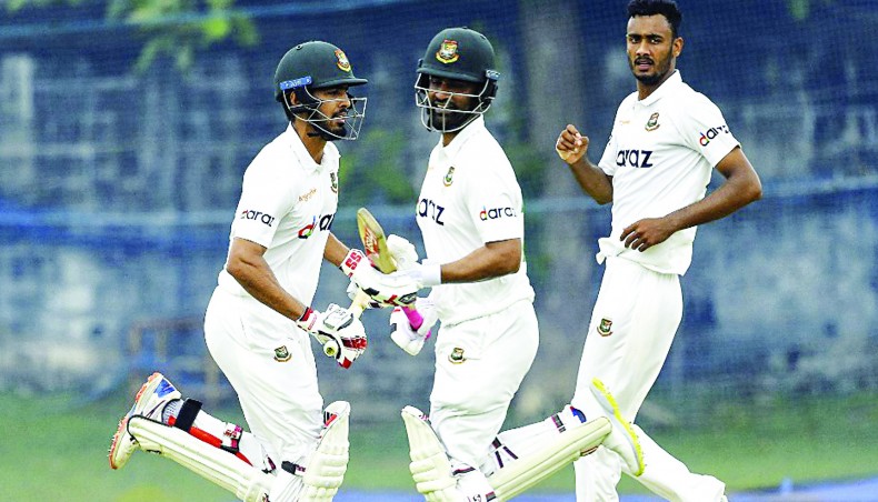 Bangladesh Red batsmen Tamim Iqbal (C) and Saif Hasan run between the wickets as Bangladesh Green pacer Shoriful Islam (R) looks on the opening day of their two-day intra-squad practice match at the Marians Cricket Club Ground in Katunayake on Saturday. — AFP photo