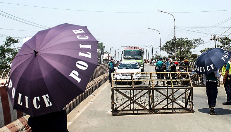 The police stop commuters at a checkpoint as the government enforced a strict restrictions to combat the spread of the COVID-19 in Dhaka on April 14. — Agence France-Presse/Munir uz Zaman
