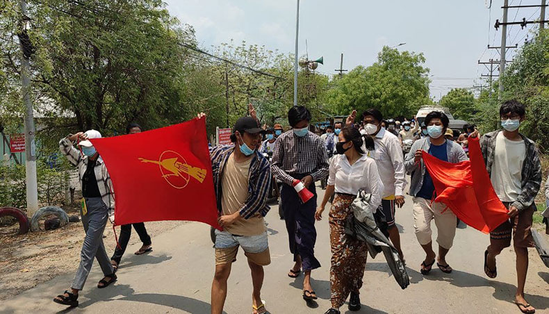 This photo taken and received on April 19, 2021 courtesy of an anonymous source via Facebook shows student protesters marching during a demonstration against the military coup in Mandalay. — AFP photo