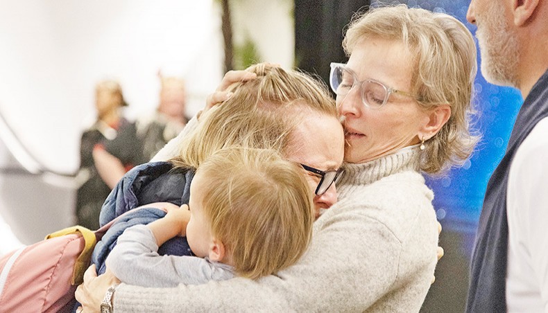 Families are reunited as travellers arrive on the first flight from Sydney, in Wellington on Monday, as Australia and New Zealand opened a trans-Tasman quarantine-free travel bubble. — AFP photo