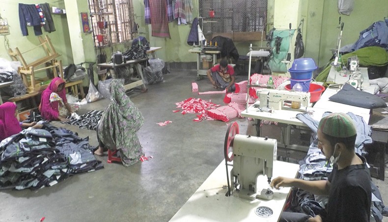Employees work at a factory manufacturing garments for the local market at Keraniganj in Dhaka on Monday. — Abdullah Apu
