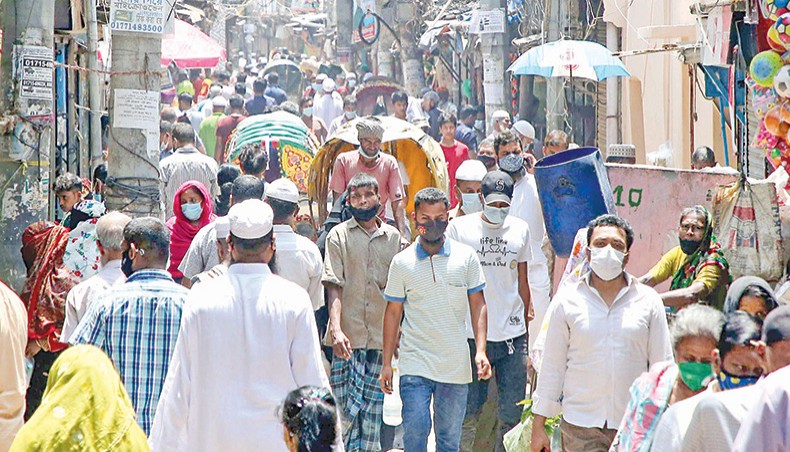 People walk down a road in Old Town of Dhaka on Monday. — New Age/Sony Ramany