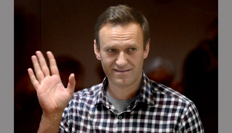In this AFP file photo taken on February 20, 2021 Russian opposition leader Alexei Navalny stands inside a glass cell during a court hearing at the Babushkinsky district court in Moscow.