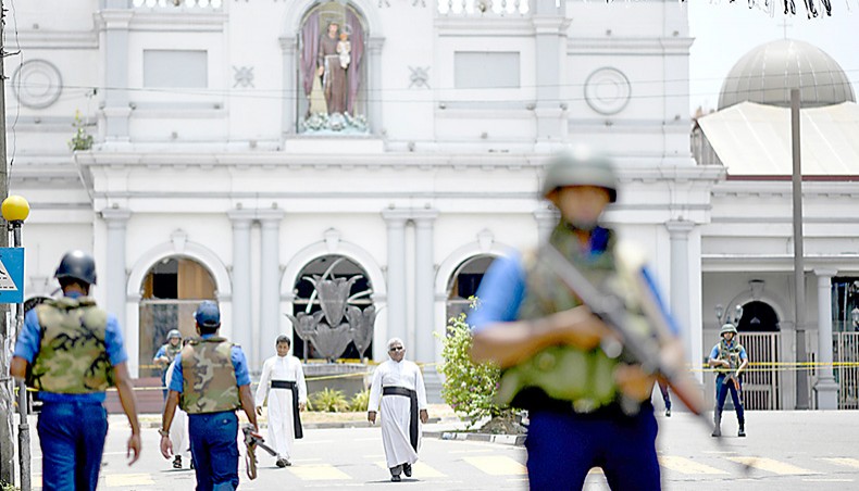 Priests walk on a blocked street as soldiers stand guard outside St Anthony’s Shrine in Colombo on April 25, 2019 afte ra series of bomb blasts targeting churches and luxury hotels on Easter Sunday in Sri Lanka. — Agence France-Presse/Jewel Samad