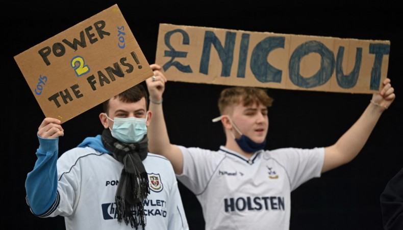 Fans hold posters reacting to the collapse of the planned creation of a European Super League, outside the Tottenham Hotspur Stadium in north London on Wednesday. — AFP photo