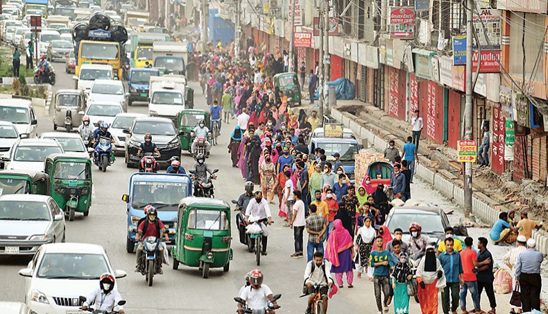 Garment workers walk back to their residences along a busy road at Banani in Dhaka after office hours on Thursday as they are not provided with transport facility during restrictions as instructed by the government. — Sourav Lasker