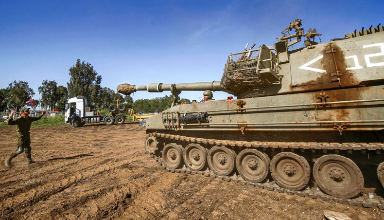 An Israeli soldier motions to the driver of an M109 howitzer mobile artillery cannon at a position near Moshav Sha’al in the Israeli-annexed Golan Heights on April 22, 2021. — AFP photo
