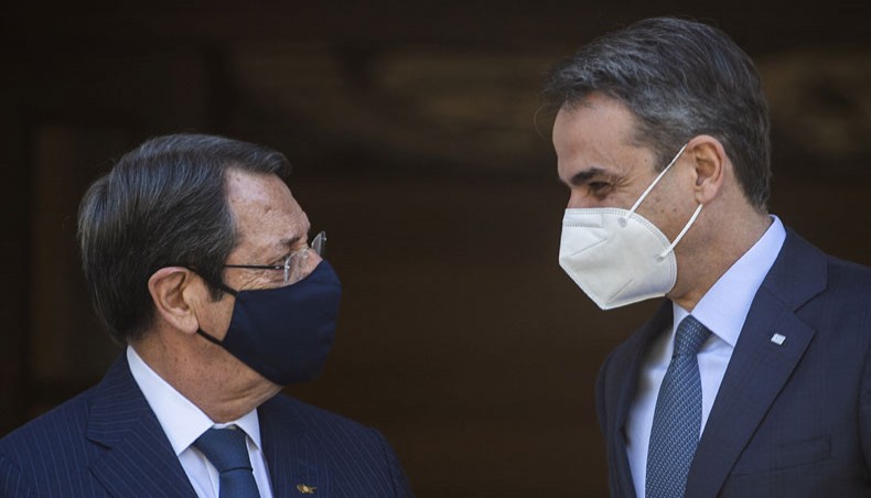 Greek prime minister Kyriakos Mitsotakis, right, welcomes Cypriot president Nicos Anastasiades, left, before their meeting at Maximos Mansion in Athens, on April 21, 2021. —AFP Photo