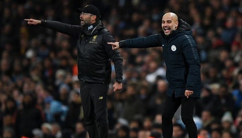 A file photo shows Liverpool manager Jurgen Klopp (L) and his Manchester City counterpart Pep Guardiola giving tips to their charges during a match.-- Twitter photo