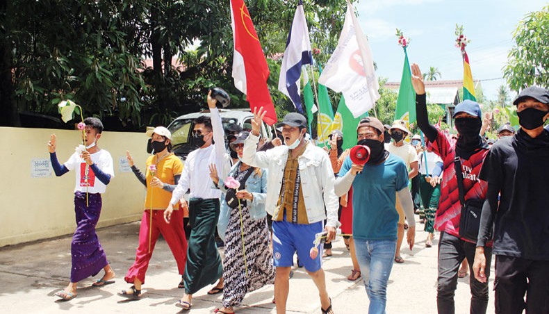 Protesters holding up the three-finger salute as they march in a demonstration against the military coup in Dawei, Myanmar on Tuesday, April 20, 2021. — AFP photo