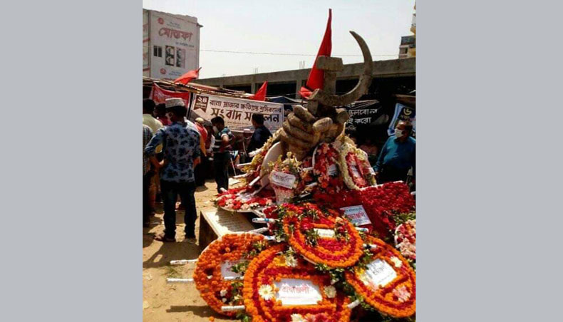 Surviving victims of Rana Plaza, different labour organisations and trade unions place wreath to the memorial sculpture of Rana Plaza victims set in front of Rana Plaza at Savar, on the outskirts of the capital on Saturday marking eight years of the incident. — New Age photo