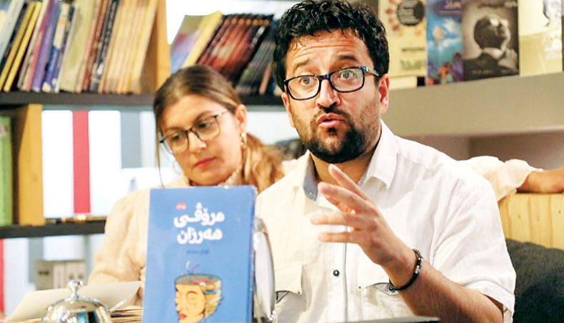 Members of a book club meet to review a novel at a book store in Arbil, the capital of the autonomous Kurdish region of northern Iraq, on April 9, 2021. — AFP photo