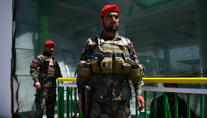 Afghan National Army soldiers stand guard at a damaged petrol station near the site of a bomb attack to a convoy of Afghan security forces, in Kabul on April 21, 2021. — AFP photo