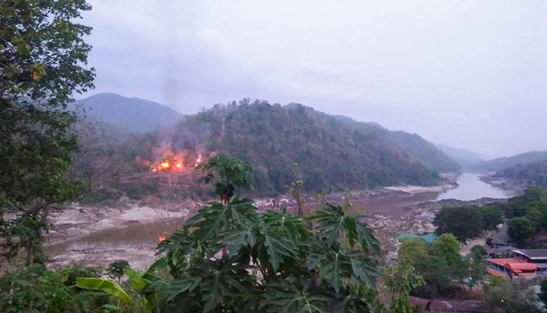This hand-out from Kawthoolei Today taken and released on April 27, 2021 shows fires burning at a Myanmar military base along the bank of the Salween river, as seen from Mae Sam Laep town in Thailand’s Mae Hong Son province, after the base was attacked and captured by the Karen National Union as the country remains in turmoil after the February 1 military coup. — AFP photo