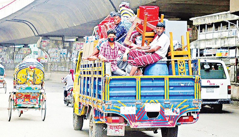 A file photo shows people leaving the capital with their belongings on a truck due to income losses amid the coronavirus outbreak in the country. The Asian Development Bank on Wednesday said that the second wave of Covid outbreak might erode at least 1 percentage point of Bangladesh’s potential gross domestic product growth in the current fiscal year 2020-2021. — New Age photo