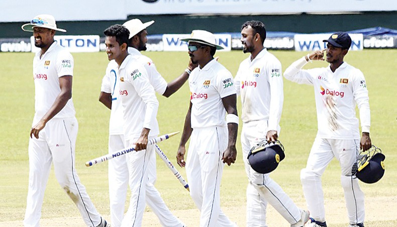 Sri Lanka’s Praveen Jayawickrama (3rd-L) celebrates with team-mates at the end of their second Test against Bangladesh at the Pallekele International Cricket Stadium in Kandy on Monday. — AFP photo