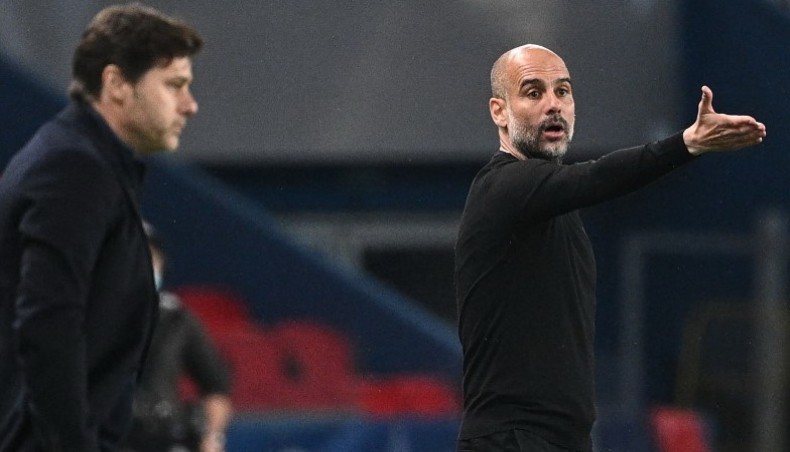A file photo from on April 28, 2021 shows Manchester City manager Pep Guardiola (R) giving instructions next to Paris Saint-Germain coach Mauricio Pochettino during their UEFA Champions League semi-final first leg match at the Parc des Princes stadium in Paris.— AFP photo
