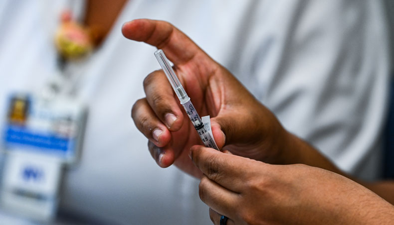In this file photo taken on April 15, 2021 pharmacy student Jason Rodriguez prepares Pfizer vaccines at the Christine E Lynn Rehabilitation Centre in Miami, Florida. — AFP photo