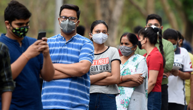 People line up to get the Covid-19 vaccine outside Moti Lal Nehru Medical College in Allahabad on May 3, 2021. — AFP photo