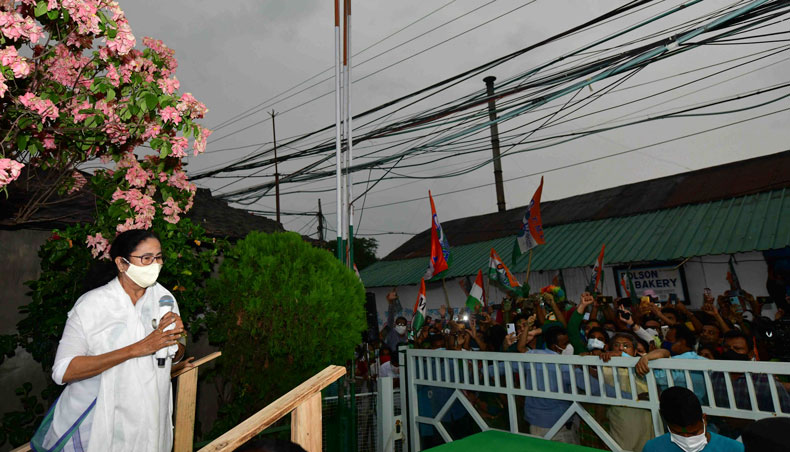 All India Trinamool Congress party leader Mamata Banerjee speaks to supporters gathered outside her home celebrating the party’s results in the West Bengal legislative assembly election, in Kolkata on May 2, 2021. — AFP photo