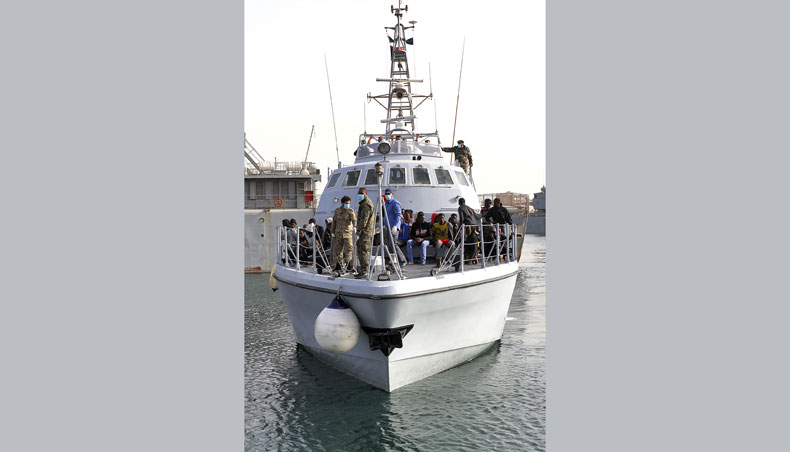 Migrants arrive at the naval base in the Libyan capital of Tripoli on April 29, 2021 after the coastguard intercepted an inflatable boat carrying 99 Europe-bound migrants off its west coast. — AFP photo