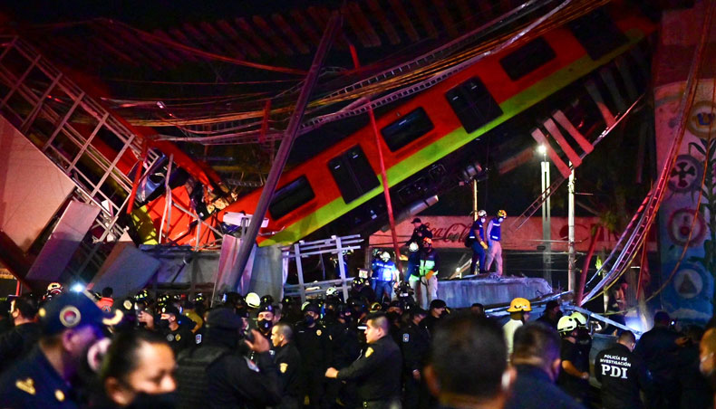 Rescue workers gather at the site of a metro train accident after an overpass for a metro partially collapsed in Mexico City on May 3, 2021. — AFP photo