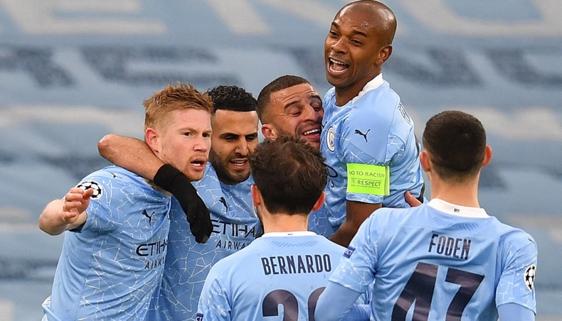 Manchester City midfielder Riyad Mahrez (2nd-L) is mobbed by his team-mates after he scored his team’s opening goal against Paris Saint-Germain during their UEFA Champions League semi-final second leg match at the Etihad Stadium on Tuesday. — AFP photo