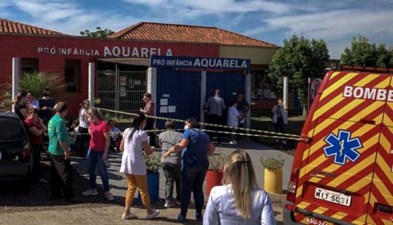Photo released by Brazilian newspaper Imprensa do Povo showing people and local authorities at the surroundings of the Aquarela Daycare School, after a 18-year-old man armed with a knife burst and killed three children and two staff, according to local police, at the southern city of Saudades, Santa Catarina state, Brazil, on May 4, 20121. — BSS
