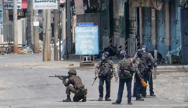 This photo taken and received from an anonymous source via Facebook on March 25, 2021 shows security forces holding weapons on a street in Taunggyi in Myanmar’s Shan state, during a crackdown on protests against the military coup. — AFP file photo