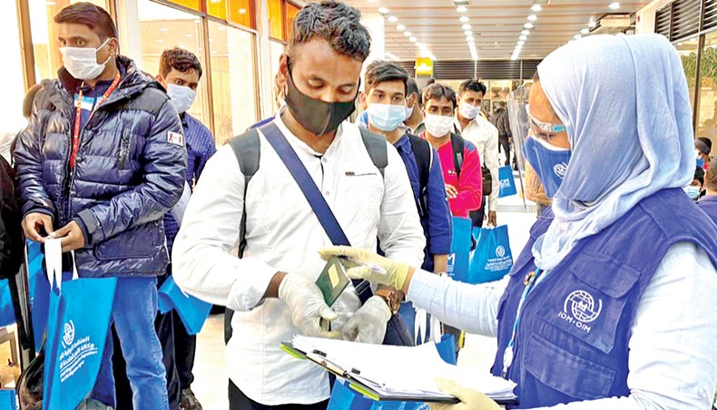 An IOM official checks information of workers who returned from Libya at Hazrat Shahjalal International Airport in Dhaka on Wednesday. — New Age photo