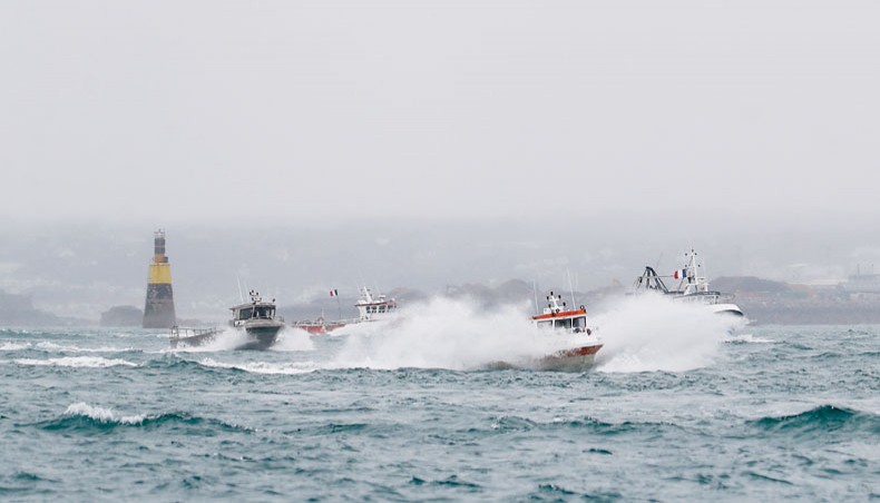 French fishing boats leave the Jersey waters following their protest in front of the port of Saint Helier off the British island of Jersey to draw attention to what they see as unfair restrictions on their ability to fish in UK waters after Brexit, on Thursday. — AFP photo