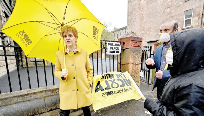 Scotland’s First Minister and leader of the Scottish National Party (SNP), Nicola Sturgeon gestures as she meets voters at Annette Street school polling station in Glasgow, Scotland on Thursday, as voters go to the polls for the Scottish Parliament election. — AFP photo