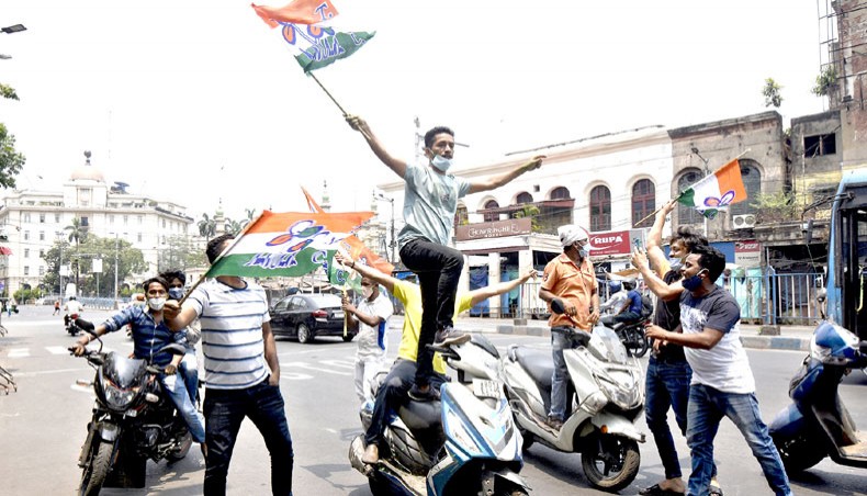 Supporters of the Trinamool Congress party celebrate their party’s lead in the West Bengal state legislative assembly elections during counting in Kolkata on May 2. — Agence France-Presse