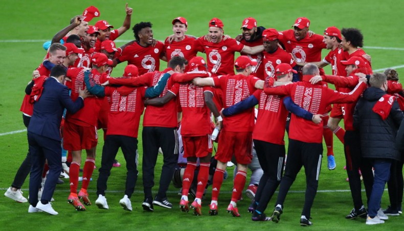 Bayern Munich players and officials celebrate after winning the Bundesliga title in Munich on Saturday.— AFP photo